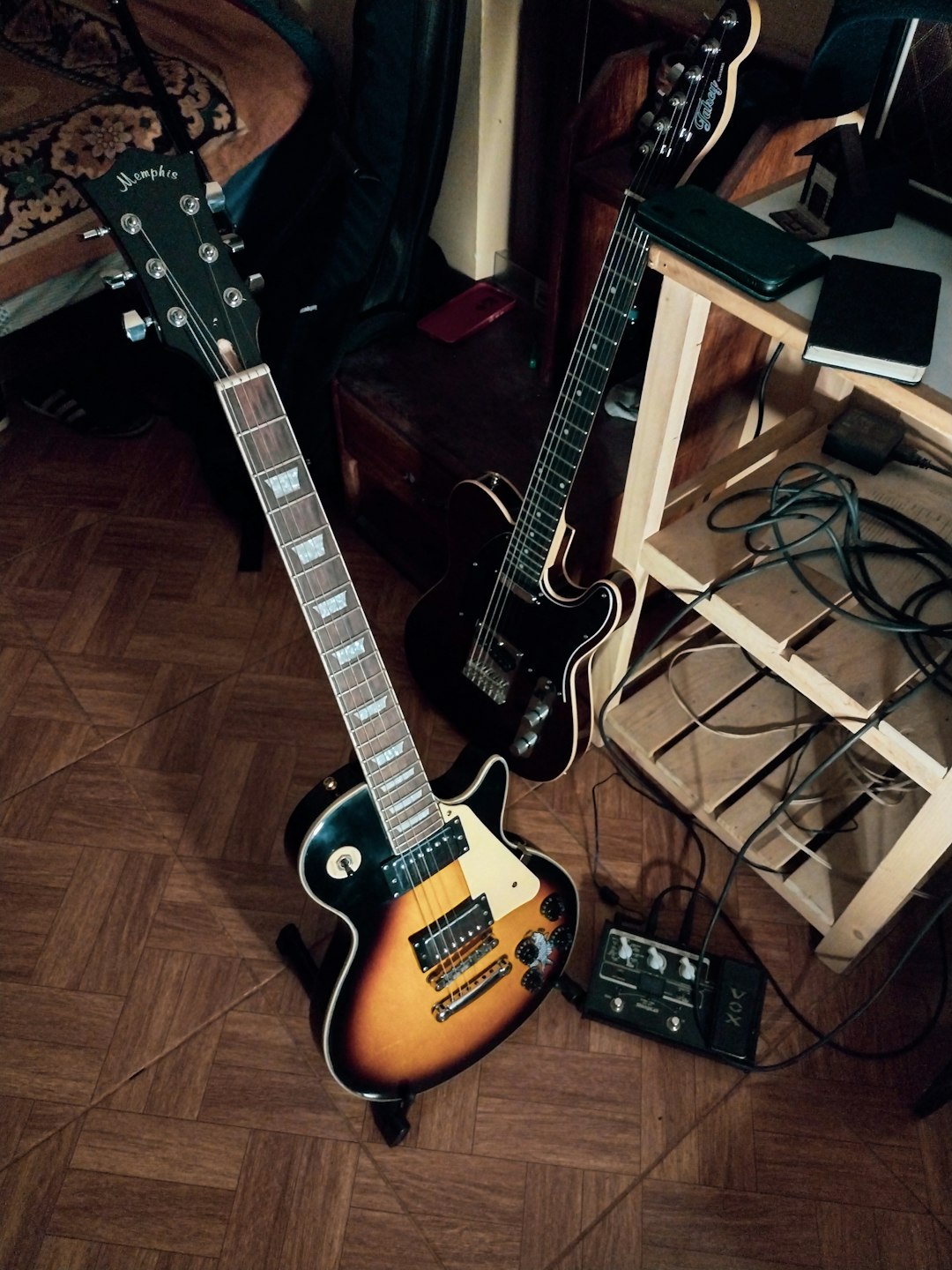 a-guitar-and-other-musical-equipment-sitting-on-the-floor-p6k8pakumqo